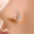 Macro shot of a silver star nose ring with white zircon on a model's piercing - Silver Star Style (SE1184)
