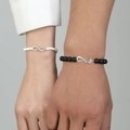 Close-up of black and white beaded couple bracelets with infinity symbol on wrists - Infinity Symbol Black and White Beaded Style (10262)