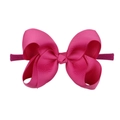 Detail view of soft pink candy-colored nylon headband with a bow for babies - Pink