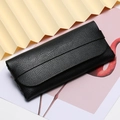 Sleek black litchi grain leather sunglass case with a minimalist flap cover design - Black