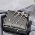 Sparkling silver bow knot long fringe tassel earrings on gray jewelry box - Silver Bowknot Tassel