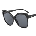 Cat-eye sunglasses with oversized black frames, V-shaped bridge and dark lenses - Black Frame Grey Lens