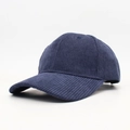 Detail of navy corduroy baseball cap showing thick vertical rib texture and curved brim - Navy Blue
