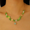 Gros plan du collier à pendentif étoile de mer et coquillage avec perles vertes - Collier avec Pendentif Étoile de Mer Bleue / Collier Doré-Étoile de Mer Bleue