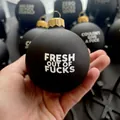 Hand holding matte black Christmas ornament featuring white Fresh Out Of Fucks text - Style C - Black Single