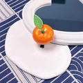 Cute realistic orange slice hair clip with green leaf and glossy finish on display - Orange