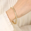 Elegant gold titanium steel bangle for women featuring a full row of sparkling zircons - Gold (29-D-10)