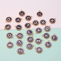 Detailed flat lay of black enamel round letter charms with gold-plated metal borders - Polka Dot Alphabet Set (DY147) / Set of 26 / Style 63 Black Polka Dot