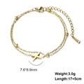 Close-up of golden stainless steel double-layered bracelet with cross charm and beads - Letter-X / Gold