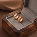 Minimalist double-lined frosted gold hoop earrings on grey velvet jewelry box padding - Rose Gold