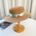 Elegant straw sun hat with light green satin ribbon on a wooden stand for women - Khaki Green Ribbon