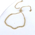 Detail of golden bead adjustable bracelet with sliding clasp and sparkling rhinestones - 3mm Gold