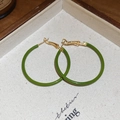Detail view of green enamel hoop earrings with gold pins on a rustic textured background - Green Circular Style (Silver Earring Post)