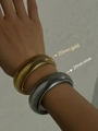 Detailed view of 20mm wide gold and silver textured ribbed bangle bracelets on wrist - Width 20mm/Length 18cm / Silver