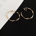 Macro shot of gold twisted hoop clip-on earring with soft pads for non-pierced ears - Clip-on Style / 4cm / Gold