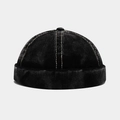 Detail of black corduroy brimless cap featuring beige contrast stitching and top button - Adjustable / Black