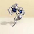 Elegant silver ginkgo leaf brooch featuring blue gemstones and a central white pearl - Ginkgo Leaf Pearl