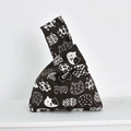 Detailed close-up of dark brown linen wrist bag with white cat patterns in Japanese style - White Cat on Coffee
