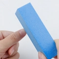 Blue 120 grit rectangle nail sanding block being used to shape fingernail edges - Blue