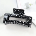 Rectangle black hair claw clip with white ink splatter pattern on a lifestyle setting - Glossy Black Splash Ink 8.5cm