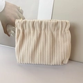 Detail of beige corduroy storage bag showing vertical texture and squeeze closure - No Label Plain / Cream