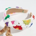 Close-up of hand-knitted floral headband with colorful embroidery on white wool base - White Base Colorful Flower Knotted
