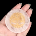 Pink quartz healing crystal disk with golden Tree of Life engraving held in hand - White Crystal Tree of Life