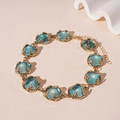 Detail of vintage golden link bracelet with blue resin stones and leaf-shaped settings - Blue Resin Necklace