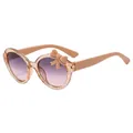Pink translucent round kids sunglasses with glitter finish and bow detail on the frame - Glitter Tea Frame