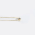 Minimalist gold necklace with a black cube pendant featuring a golden letter S engraving - S