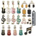 Detail of colorful enamel musical instrument pendants including guitars and microphones - Enamel Music Charms Set A