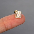 Close-up of gold stud earring with cubic zirconia rectangle held on a fingertip - 3# Rectangular Cluster / Gold