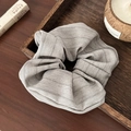Detail of grey herringbone fabric scrunchie on a Zen-style wooden tray - Striped/Herringbone Texture / Off White