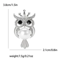 Macro view of silver owl brooch with white pearl and rhinestone detailing and dimensions - Silver