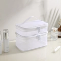 Close-up of dual white mesh makeup bags with sturdy handles and smooth zipper closure - White