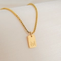 Detail of 18K gold plated square pendant with letter M engraving on box chain necklace - Letter M