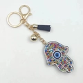 Golden Hamsa hand keychain with blue evil eye, colorful rhinestones and black tassel - Multi-color