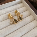 Macro detail of gold gourd earrings with tiger eye stone and crystals on beige velvet - Ear Buckle-Gold-Brown-Gourd Shape (HE29022-WE4986)