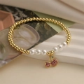 Golden bead bracelet with pearls and red zircon cherry pendant on white marble steps - E000420YS-Red Zircon Cherry