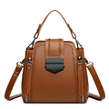 Brown PU leather crossbody bag with top handle and black metal lock on white background - Yellow