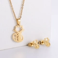 Detailed view of hollow cat pendant necklace and matching stud earrings in gold finish - Cat