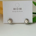 Elegant oval freshwater pearl stud earrings with a silver-toned textured sunburst frame - Silver Sunburst Oval Pearl Stud