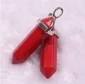 Detail of red hexagonal stone pendants with silver metal clasps on white faux fur - Red Howlite