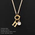 Gold stainless steel necklace with crystal tennis chain and letter 'h' pendant. - Letter N (XNL0103)