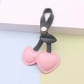 Pink PU leather cherry keychain pendant with dark green leaves and a metal snap button - Green Stem Pink Fruit