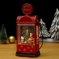 Close-up of vintage red gas station snow globe with Santa Claus and sparkling glitter - Santa Claus and Boy