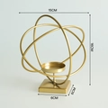 Golden iron geometric candle holder with nested rings and measurements on gray background - Globe-Gold