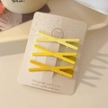 Set of 3 yellow matte criss-cross hair clips on a stylish beige polka dot card - Yellow Gradient Cross Set