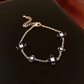Bracelet élégant en or avec fleurs en émail noir et pierres de zircon scintillantes - Bracelet Zirconia Fleur Noir Or