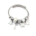 Detail view of silver charm bracelet with white beads, star and elephant pendants - White